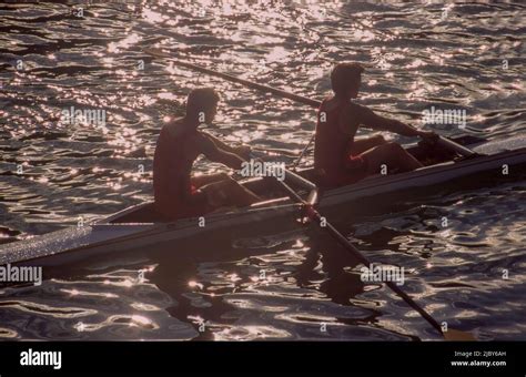 Two men rowing in double scull on water Stock Photo - Alamy