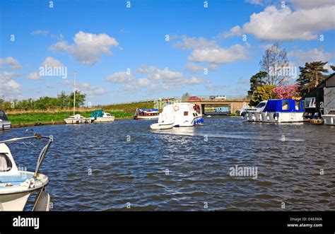 A view of a motor cruiser approaching Ludham Bridge on the Norfolk ...