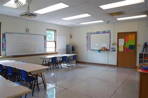 Organized Classroom With Desks Arranged Neatly In Rows Facing A