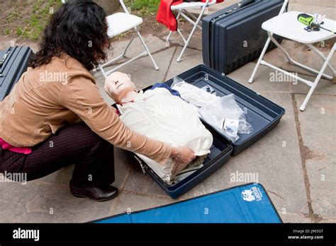 Woman Putting Away Cpr Manikin In Its Case Aka Rescue Anne Resusci