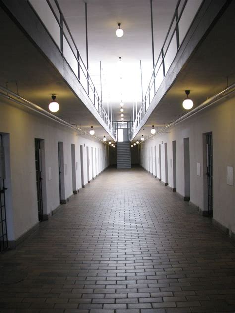 An Empty Hallway With Several Doors And Lights