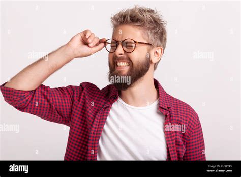 Portrait Of Funny Extremely Happy Bearded Man Touching Eyeglasses