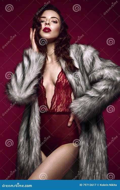 Beautiful Long Haired Brunette Woman In Red Lingerie And Fur Coat