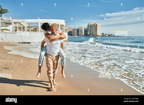 Lovely Gay Couple On Piggyback Ride At The Beach Stock Photo Alamy