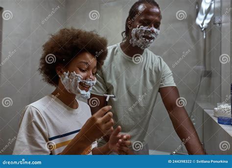 Father Teaching His Smiling Son Shaving With Razor Stock Photo Image