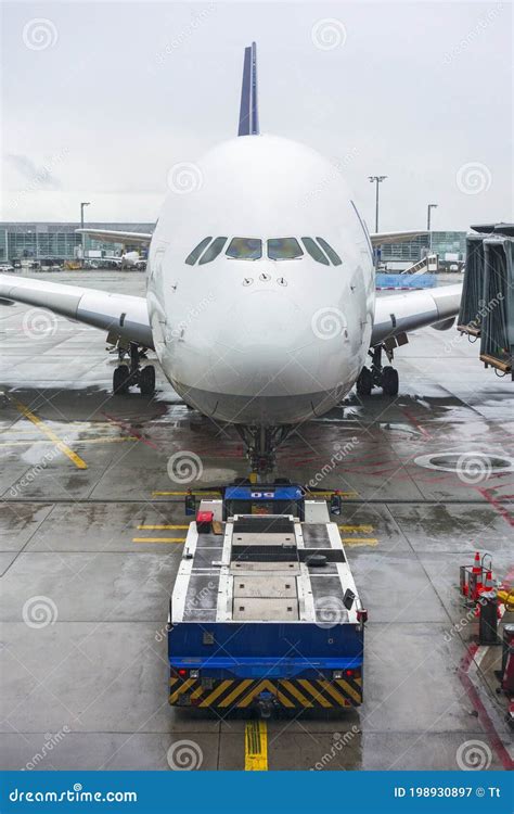 Pushback Tug and a Large Airplane at an Airport Stock Image - Image of workplace, place: 198930897