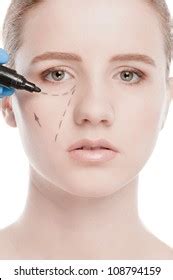 Beautician Draw Correction Lines On Woman Stock Photo