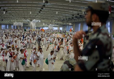 Muslim Pilgrims Walk On The Way To Cast Stones At The Huge Stone Pillar