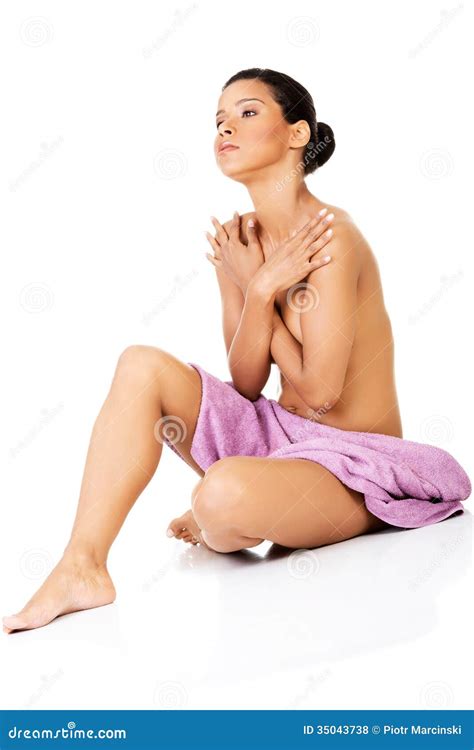 Attractive Naked Woman Sitting Covered With Towel Front View Stock