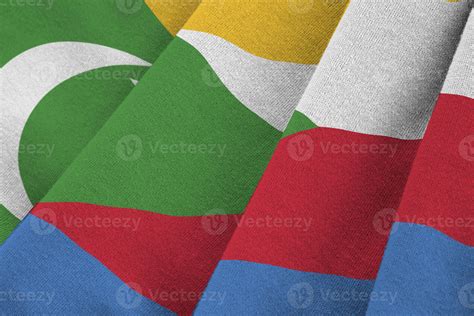 Comoros Flag With Big Folds Waving Close Up Under The Studio Light