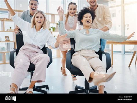 Happy Corporate Colleagues Having Fun And Being Playful In An Office