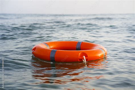 Red Lifebuoy In Sea On Water Life Ring Floating On Top Of Water Life