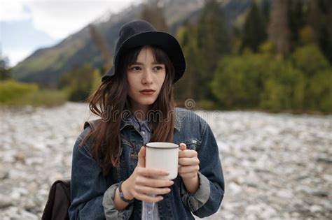 Hands Holding Hot Cup Of Coffee Or Tea In Morning Sunlight With Buautiful Mountain Background