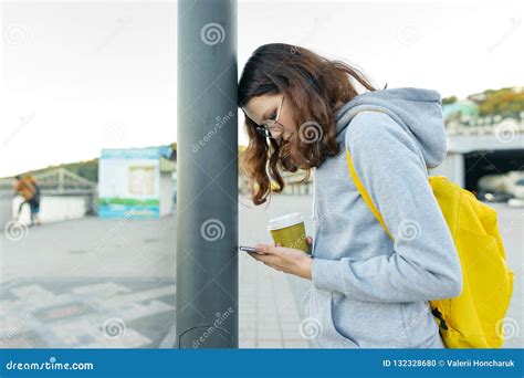 Smart Focused Girl Is Distracted By Mobile Phone Girl Reading