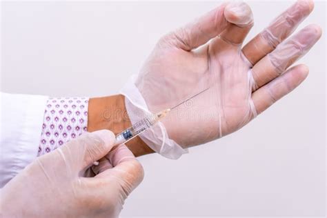 Gloved Doctor Hands Holding An Injection Vial Of A Hyaluronic Acid Ha