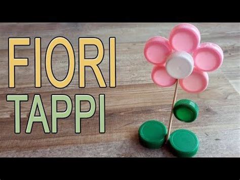 A Flower Made Out Of Plastic Cups Sitting On Top Of A Wooden Table With