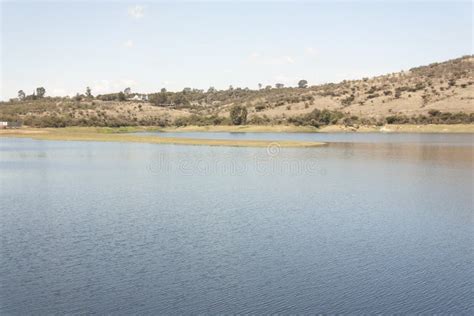 Outdoor Body Of Water Surrounded By Land And Blue Sky Stock Photo