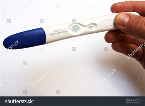 Hand Holding Positive Pregnancy Test ภาพสต็อก แก้ไขตอนนี้ 50465716