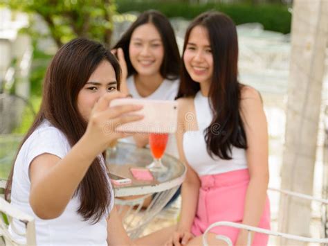 Three Happy Young Asian Women As Friends Taking Selfie Together At The