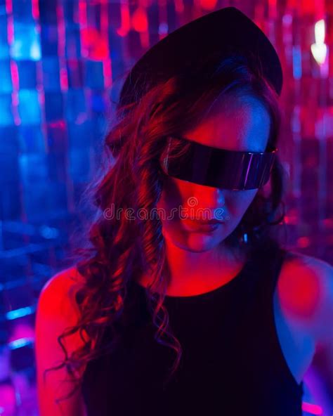 Close Up Portrait Of A Caucasian Woman In Sunglasses In Neon Light