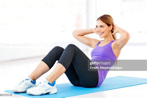 Woman Doing Situps On Exercise Mat In Gym High Res Stock Photo Getty