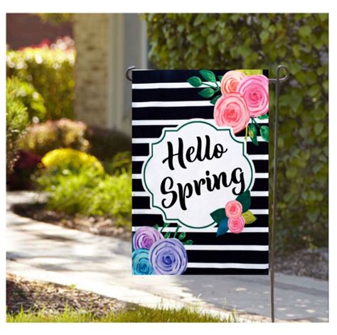 A Black And White Striped Flag With Flowers On It That Says Hello