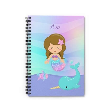 A Spiral Notebook With An Image Of A Mermaid On The Cover And A Dolphin