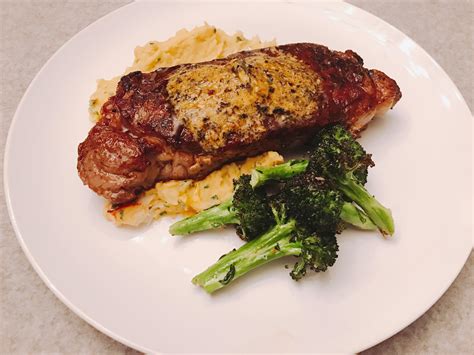 Homemade Seared New York Strip Steak With Umami Butter Served Over King Crab Mashed Potatoes