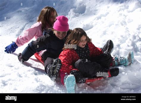 Three Snow Girls On Sled Stock Photo Alamy