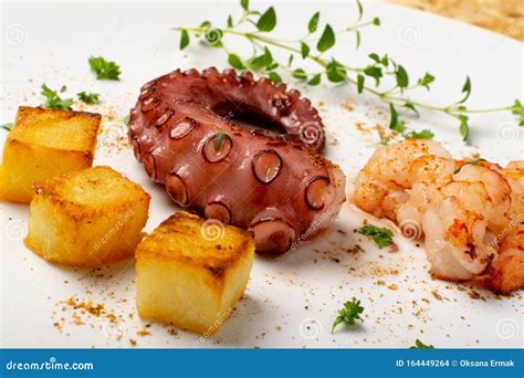 Grilled Octopus On White Restaurant Plate Served With Shrimps Stock