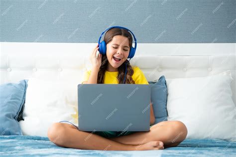 Premium Photo Happy Teen Teenage Girl In Headphones Relax On Bed At