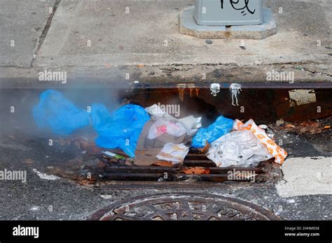 A Steamy Pile Of Garbage Clogging A Storm Drain Catch Basin Sewer