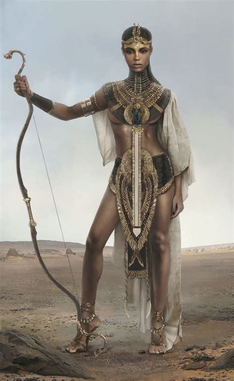 A Woman Dressed In Egyptian Clothing Holding A Bow And Arrow While