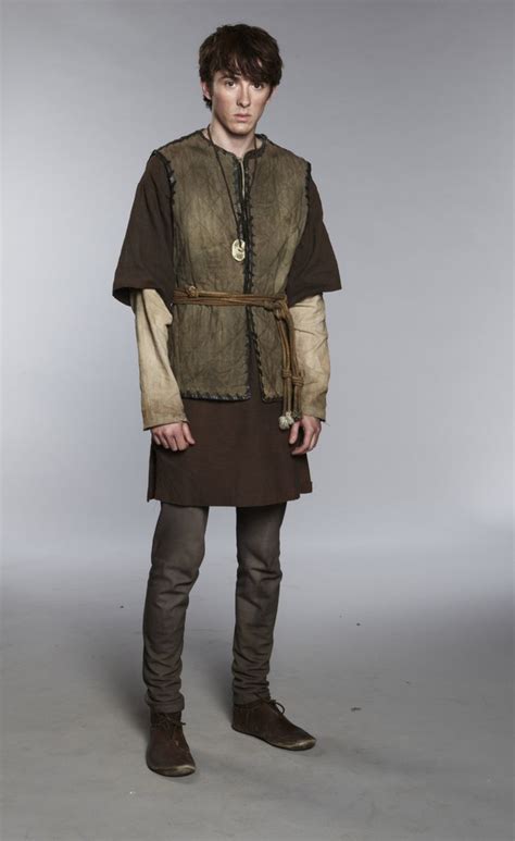 A Young Man Dressed In Medieval Clothing Posing For The Camera With His