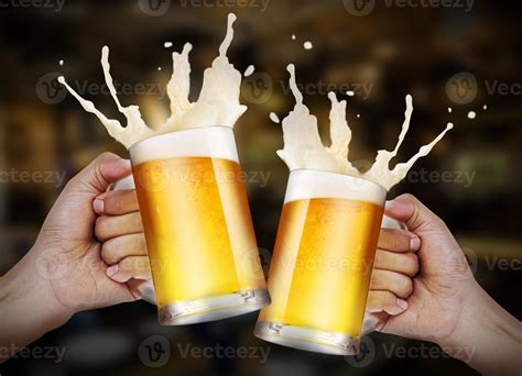 Two Hands Holding A Glasses Of Light Beer Toasting With Bubble Froth