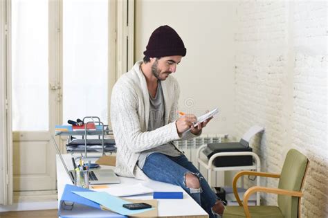 Trendy Businessman In Cool Hipster Beanie And Informal Look Writing On