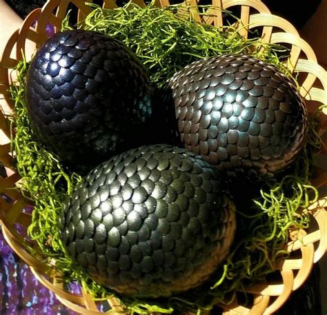 Three Black Dragon Eggs In A Basket With Moss