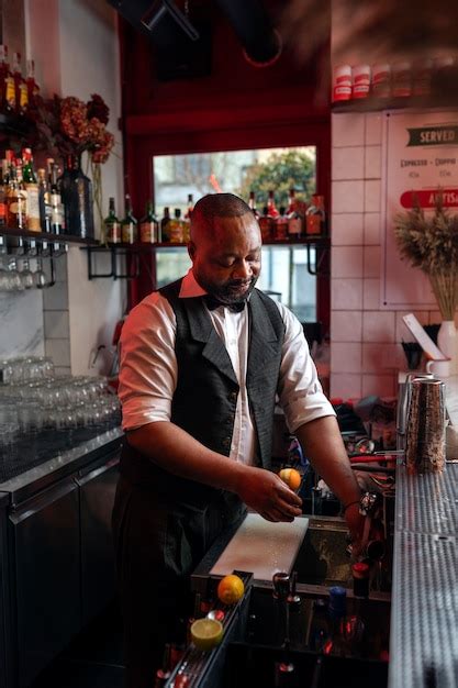 Free Photo Bartender Preparing Drink At Bar