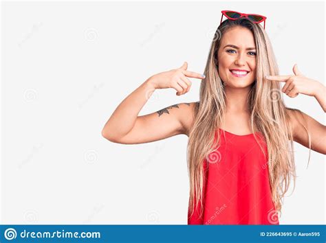 Young Beautiful Blonde Woman Wearing Sleeveless T Shirt And Sunglasses Smiling Cheerful Showing