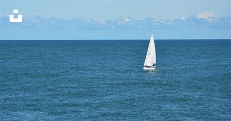 White Sailboat In Body Of Water During Daytime Photo Free Blue Image