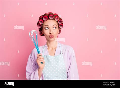 Photo Of Thoughtful House Wife Wear Dotted Blue Apron Red Rollers