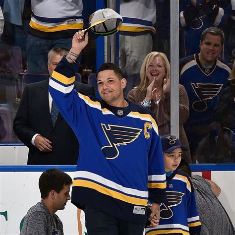 A Hockey Player Waves To The Crowd From The Bench