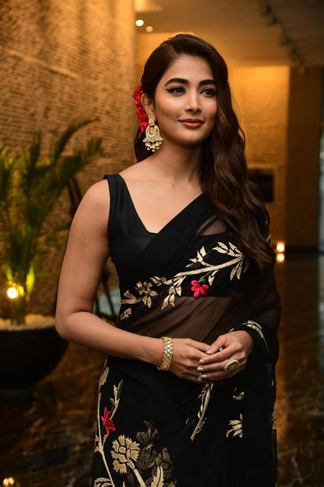 Pooja Hegde Goes Retro In A Black Floral Saree For Acharya Promotions