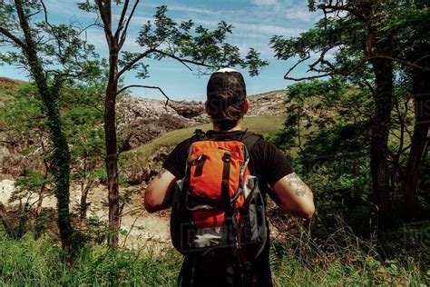 Back View Of Anonymous Hipster Male Traveler In Casual Clothes With