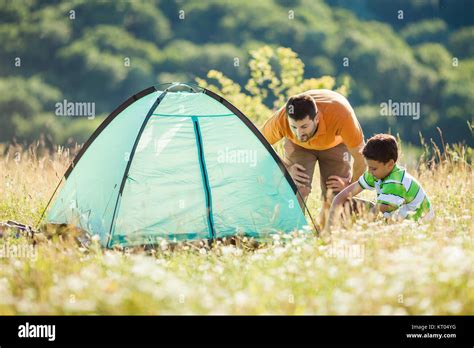 Father And Son Are Setting Up Their Tent In Nature Stock Photo Alamy