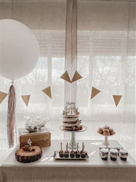 A Table Topped With Cake And Desserts Next To A Window