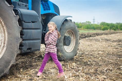 Cute Girl Near the Modern Tractor in the Field Stock Photo - Image of female, cultivation: 165315348