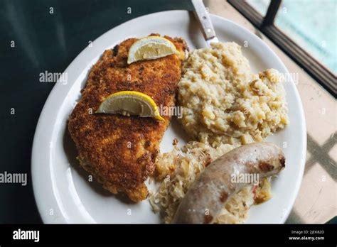 German Pork Schnitzel With A Side Of Sauerkraut A Bratwurst Sausage