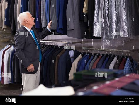 Mature Customer Looking Jacket In Men Clothes Store Stock Photo Alamy
