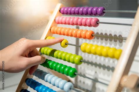 Male Hand Calculating With Beads On Wooden Rainbow Abacus For Number